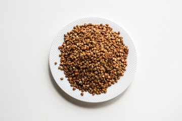 buckwheat in bowl isolated on white