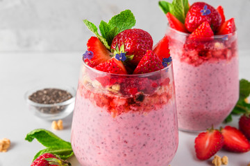 strawberry yogurt with chia seeds, fresh berries, granola and mint for healthy tasty breakfast