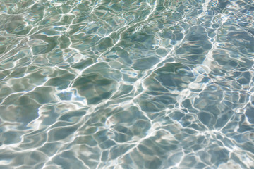 blue water ripples in a summer swimming pool