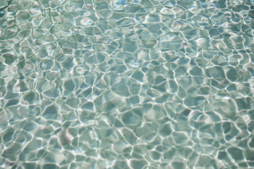 blue water ripples in a summer swimming pool