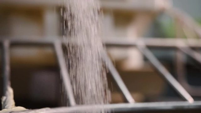 Close-up of sugar poured into dough mixer. Stock footage. Sugar is poured into mixer for mixing with dough when cooking sweet pastries