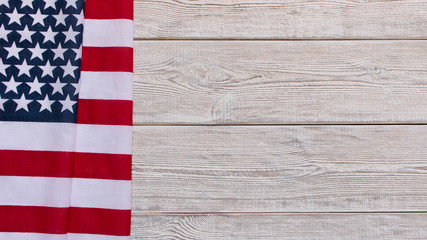 Fototapeta na wymiar American flag on a wooden background. The concept of freedom and patriotism.