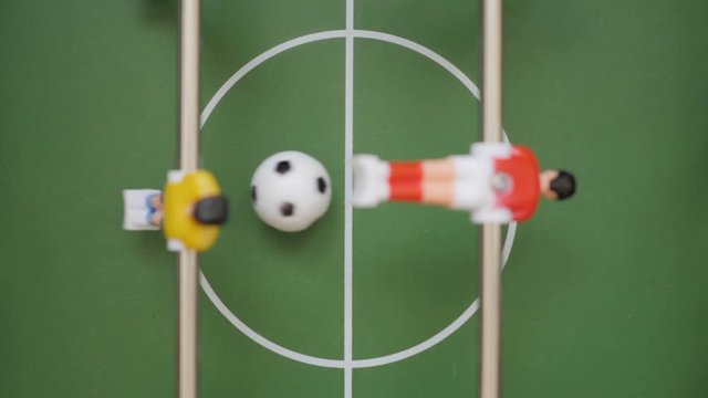 Friends Playing Table Soccer Game Closeup. People playing in table football or kicker with miniature players. Slow Motion. Shallow DOF. Playing Football Soccer on game table. Close Up.