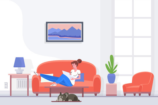 Relaxed female sitting on couch and browsing laptop while spending time at home.