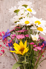 Bouquet of field flowers with sunflower chamomile, cornflowers