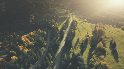 Fototapeta na wymiar Colorful Hill Forest Country Road Aerial View. Mountain Sunset Landscape long Curve Driveway Overview. Highland Meadow Eco Friendly Environment Holiday Concept Timelapse Drone Flight