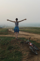 white european young woman stand and keep hands to side