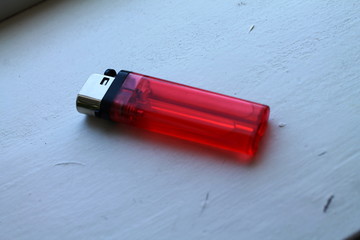 red lighter isolated on black background
