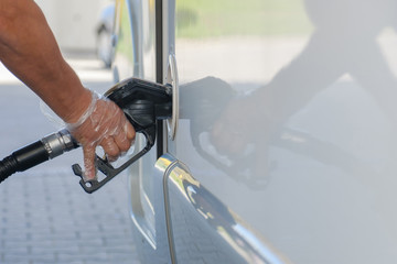 Man is refueling in car.