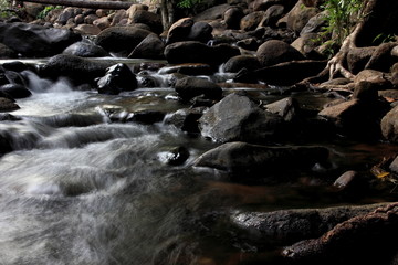 Forest river waterfall view.Mountain stream with blurred motion of waterfall.