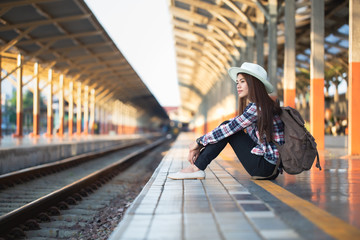 Obraz premium Active and travel lifestyle concept, Woman traveler tourist walking with luggage at train station.