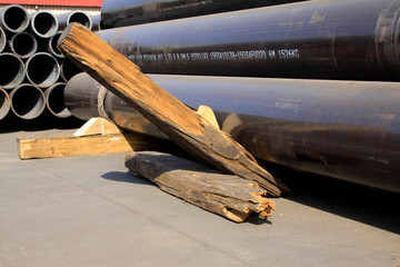 Steel pipe and crowbar on shipping dock