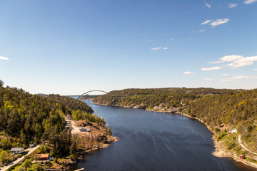 Arch bridge over river against clear blue sky
