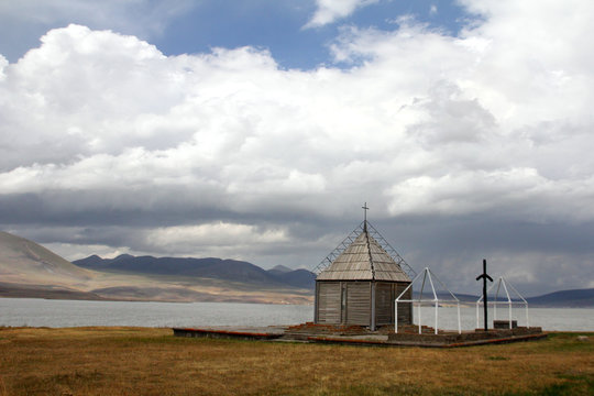 Small church under a huge white cloud