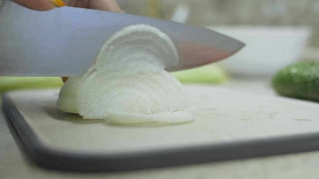 woman knife onion slices onion