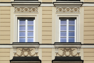Fototapeta na wymiar Window decoration of buildings of Krakow suburb street.