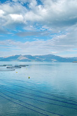 Salmon farm in a fjord between   mountains in Western Norway Hardanger fjord area at summer.