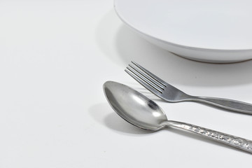  Spoon and fork placed with the bowl
