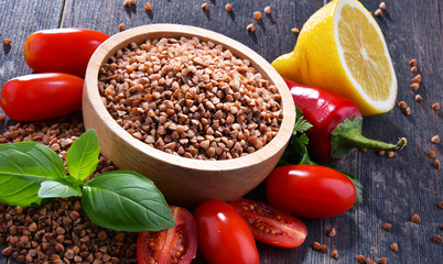 Bowl of buckwheat kasha on wooden table