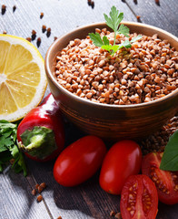 Bowl of buckwheat kasha on wooden table