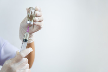 doctor's hand holds a syringe and a vaccine bottle at the hospital. Health and medical concepts