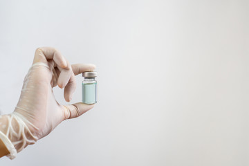 Closeup of a doctor with a bottle of vaccine.. Health and medical concepts