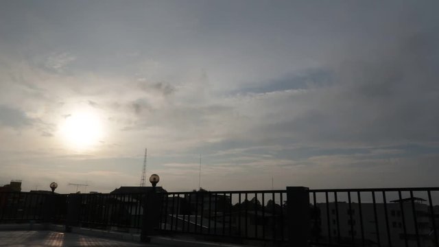 Time Lapse of Sunset On a Building Rooftop in a Small City in Thailand With Moving Clouds