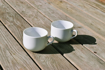Two cups  on wooden table