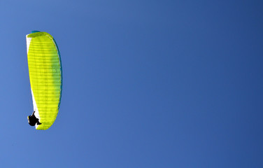 paraglider flight through the blue sky