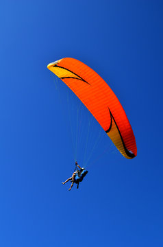 paraglider flight through the blue sky