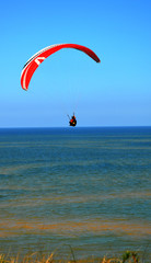 paraglider flight through the blue sky