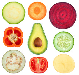 Isolated vegetable slices. Collection of fresh cut vegetables (zucchini, carrot, beetroot, bell pepper, avocado, cucumber, eggplant, tomato, potato) isolated on white background with clipping path
