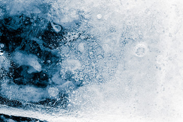 Ice texture background. Textured frosty surface of ice blocks against black.
