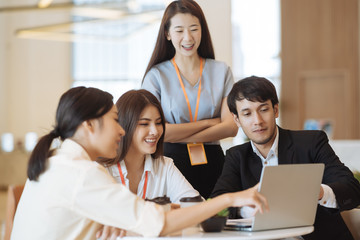 Fototapeta premium Young Asian woman and business people are meeting in office discussion with colleagues . Group of Business team working and share ideas about project to partners