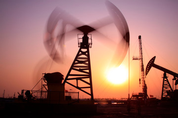 Crank balanced beam pumping unit in Jidong oilfield sunset scenery, closeup of photo