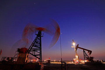 Crank balanced beam pumping unit in Jidong oilfield sunset scenery, closeup of photo