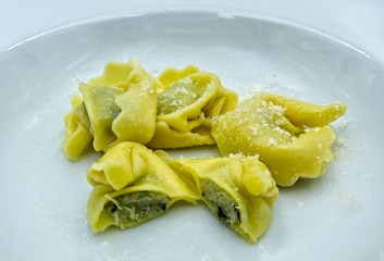 Tortelloni with ricotta cheese and spinach on white dish