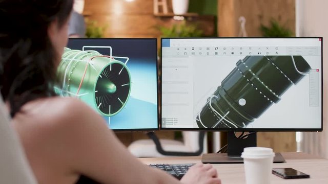 Professional creative media agency office. Over the shoulder shot of 3D designer working on new turbine prototypes