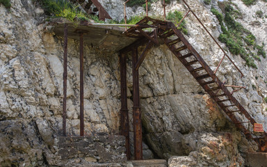 Freshwater Bay: rusty and derelict staircase on a cliff