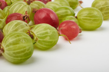 Gooseberries fruits on white background. Bowls with gooseberries isolated on white background. Red and green gooseberries in a bowl with copy space for text. Ripe gooseberry close-up.  K