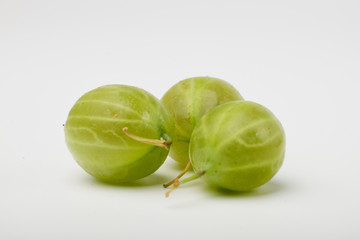 Gooseberries fruits on white background. Bowls with gooseberries isolated on white background. Red and green gooseberries in a bowl with copy space for text. Ripe gooseberry close-up.  K