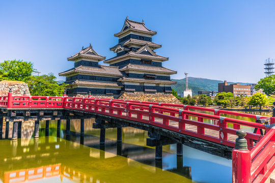 Matsumoto - May 25, 2019: The castle of Matsumoto and the red bridge leading to it, Japan