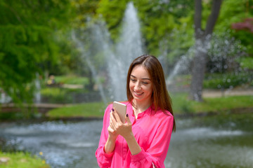 Happy young woman chatting on a mobile phone