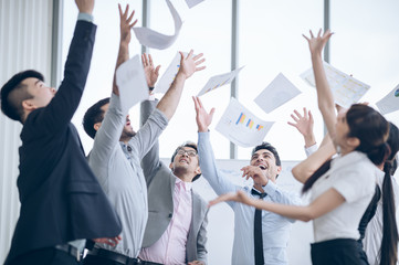 Fototapeta na wymiar Successful group of coworkersThrowing paper in the air