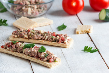 open sandwiches with crispbread tuna salad tomatoes cucumber boiled egg on white table .healthy snack