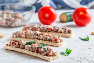 homemade open sandwiches with crispbread tuna salad tomatoes cucumber boiled egg on white table .healthy food snack