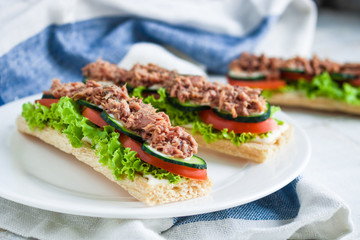 homemade open sandwiches with rice diet  crispbread  tuna lettuce cucumber tomato on  plate on the table. healthy food