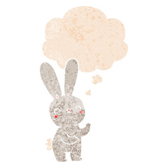 cute cartoon rabbit and thought bubble in retro textured style