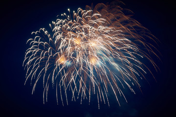 A large beautiful sparkling bright fireworks, descending fountain and splashes, yellow, against the...