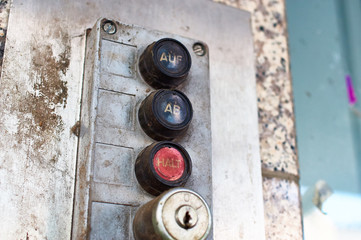 Dirty switch of a garage door with in german AUF AB HALT in english UP DOWN STOP